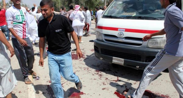 People gather at the site of a bomb attack in Baquba, about 50 km northeast of Baghdad yesterday that left   at least 43 people dead in one of the deadliest incidents in a month-long surge in sectarian violence. Photograph: Reuters