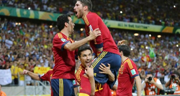Spain’s Jesus Navas (bottom) celebrates with his teammates after scoring the winning penalty  against Italy in the  shoot-out of their Confederations Cup semi-final  at the Estadio Castelao.