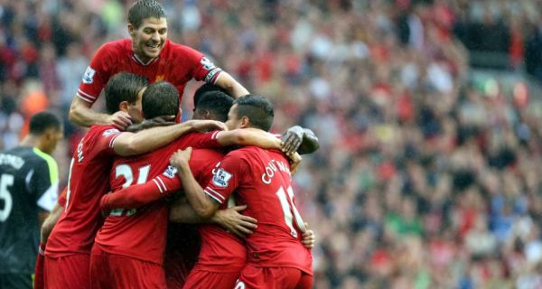 Liverpool’s Daniel Sturridge celebrates with Steven Gerrard (top) and team mates after scoring the winner against Stoke City at Anfield. Photograph: Peter Byrne/PA Wire. 