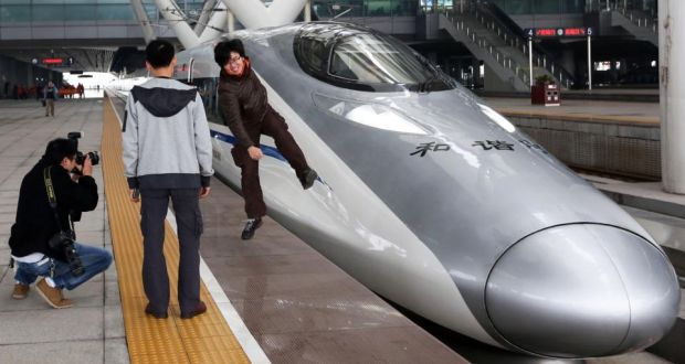 On a high: passengers before boarding a high-speed train on the new 2,298km (1,425-mile) line between Beijing and Guangzhou in China. The line is the latest milestone in the country?s super-fast rail network. photograph: str/afp/getty images