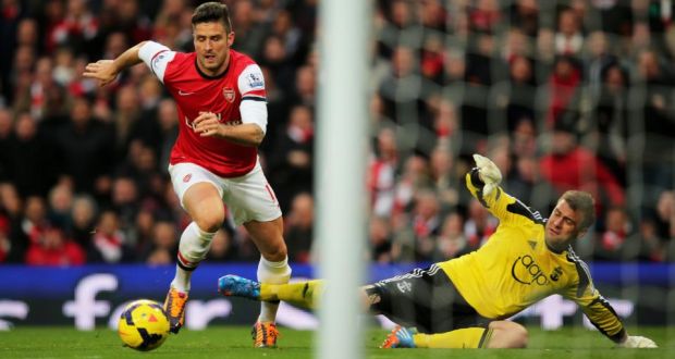 Arsenal’s Olivier Giroud rounds Artur Boruc to score his first goal. Photograph: Clive Rose/Getty Images