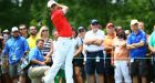 Rory McIlroy keeps a close eye on his tee shot on the first hole during the first round of the Memorial Tournament at Muirfield Village in Dublin, Ohio yesterday.