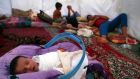 A baby sleeps with his family, who fled from the violence in Mosul, inside a tent yesterday at a camp on the outskirts of Arbil in Iraq’s Kurdistan region. Photograph: Reuters/Azad Lashkari 