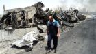 A man walks past near remains of burnt vehicles belonging to Iraqi security forces in the northern Iraq city of Mosul. Photograph: Reuters