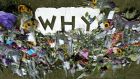 Flowers laid in tribute to the victims of flight MH17 around a cutout reading “Why”, near the entrance to the military airport in Eindhoven, southern Netherlands yesterday. Photograph: Marcel Van Hoorn/EPA 