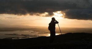 A lone pilgrim takes a moment of contempletation as he makes his way up Croagh Patrick, Co Mayo at dawn. The last Sunday in July has been a day of Christian pilgrimage for more than 1,000 years. Photograph: Michael Mc Laughlin
