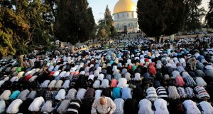 ISRAEL: Muslim worshippers take part in a prayer in front of the Dome of the Rock during the holiday of Eid al-Fitr on the compound known to Muslims as al-Haram al-Sharif and to Jews as Temple Mount in Jerusalem's Old City. Photograph: Ammar Awad/Reuters