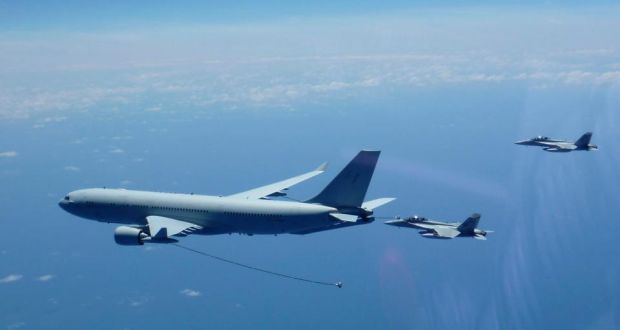 A handout picture made available by the Australian Department of Defense shows two Royal Australian Air Force (RAAF) F/A-18F Super Hornet aircraft conducting a mid air refuelling from a RAAF KC-30A Multi-Role Tanker Transport en route to the Middle East Region.