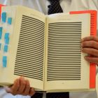 Censored: Mohamedou Ould Slahi’s brother Yahdih Ould Slahi shows redacted pages of Guantánamo Diary. Photograph: Ben Stansall/AFP/Getty