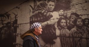 Holocaust survivor Igor Malicky (90) pauses for thought as he tours an exhibition inside the former Auschwitz I concentration camp ahead of commemorations marking the 70th year since its liberation. Photograph: Christopher Furlong/Getty Images
