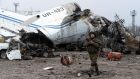 An armed fighter of the self-proclaimed People’s Republic of Donetsk walks past a damaged airplane in the destroyed airport of the eastern Ukrainian city of Donetsk. Photograph: Vasily Maximovvasily/AFP/Getty images