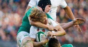 England's Billy Twelvetrees is tackled by Ireland's Tommy O'Donnel. Photograph: Cathal McNaughton/Reuters