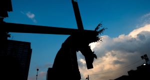 Carrying a crucifix in the procession of the Nazarene of "Saint Paul Christ's day", as part of Holy Week, outside the Santa Teresa church in Caracas, Venezuela, on April 1st, 2015. Photograph: Federico Parra/AFP/Getty Images
