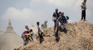 Nepalese police and volunteers clear the rubble while looking for survivors at the compound of a collapsed temple, following Saturday's earthquake, in Kathmandu, Nepal. Photograph: Danish Siddiqui/Reuters
