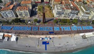 Chinese industrialist Li Jinyuan  brought 6,400 of his employees on holiday to France in May – a trip that cost more than €13million – where they formed a record-breaking ‘longest human phrase’, reading ‘Tiens’ dream is Nice in the Côte d’Azur’. Photograph: Valery Hache/AFP/Getty Images