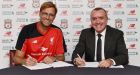 Jurgen Klopp signs a three year deal as Liverpool’s new manager. Photograph: Getty Images