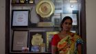 Asha Singh, mother of Late Jyoti Singh (Nirbhaya), victim of the 2012 bus gang rape in her home in front of a cabinet with mementos given to her in honor of her daughter. Photographs: Arkaprava Ghosh / Barcroft India via Getty Images and Natisha Mallick