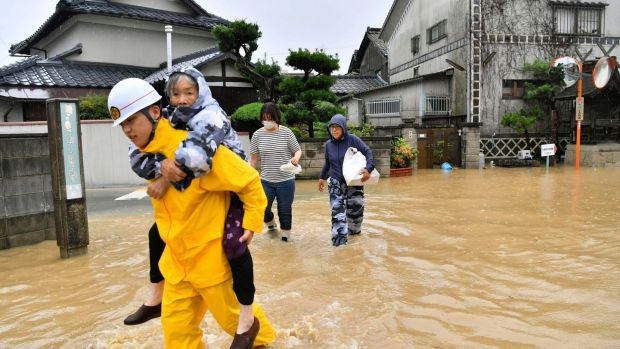   Residents are evacuated from floodwaters caused by heavy rains in Kurashiki, Okayama Prefecture. The torrents of rain and floods continued to hit southwestern Japan. Photo: AP 