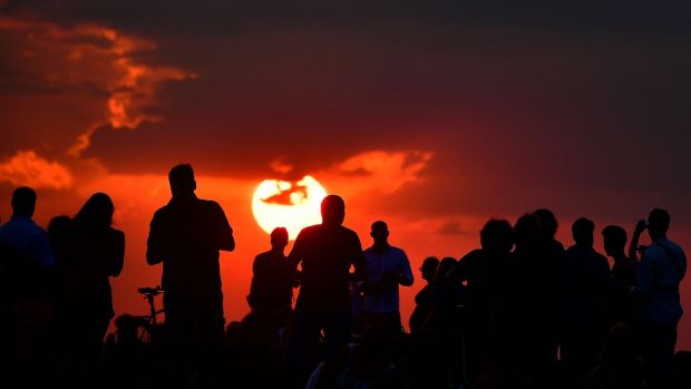   People gather while waiting for the sun to set and the appearance of the blood moon in Berlin. Photo: Tobias Schwatrz / AFP / Getty Images 