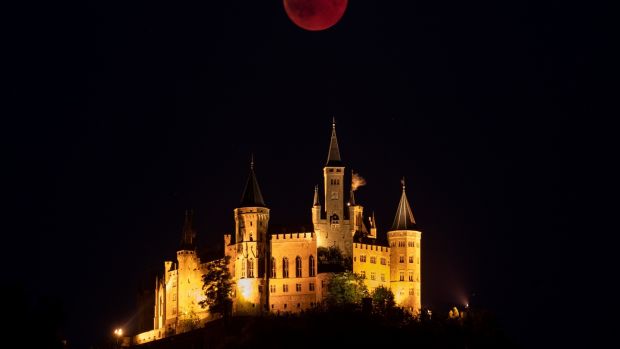   A Bloody Moon stands behind Hohenzollern Castle, ancestral seat of the Prussian Royal House and Princes Hohenzollern, located on the outskirts of the Swabian Alb in Hechingen, Germany. Photograph: Matthias Hangst / Getty Images 