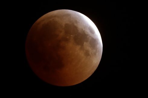   The moon in total lunar eclipse over the Lebanese city of Tannourine in the mountains north of Beirut. The longest 