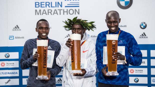   Kipchoge (C), together with Amos Kipruto and Wilson Kipsang (R), established Kenya during the ceremony. Photo: Maja Hitij / Bongarts / Getty Images 