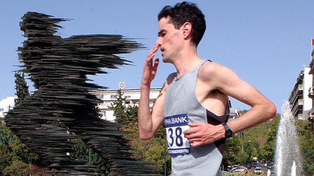 Ian O’Riordan from Ireland pbades by the statue “The Runner” during the Athens Clbadic Marathon in 2003. Photograph: Orestis Panagioutou/EPA