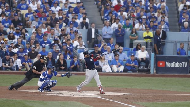 Steve Pearce hits home with two points in the first leg of the fifth World Series game. Photography: Larry W Smith / EPA