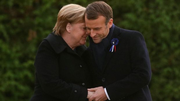 French president Emmanuel Macron and German chancellor Angela Merkel hug after unveiling a plaque in the Clairiere of Rethondes during a commemoration ceremony for Armistice Day, 100 years after the end of the first World War, in Compiegne, France. Photograph: Philippe Wojazer/EPA
