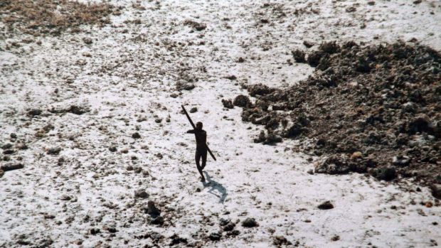 A man from the Sentinelese Tribe is pointing his bow and arrow at an Indian Coast Guard helicopter as he flies over North Sentinel Island in the Andaman Islands, following the 2004 tsunami in the United States. ;Indian Ocean. Photography: Document / AFP / Getty Images