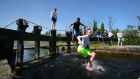 Children jumping into  the Grand Canal in Inchicore, Dublin on Tuesday. Photograph: Nick Bradshaw