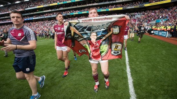 Galway’s Conor Whelan celebrates after the All-Ireland final win with a Galway flag bearing Niall’s image. Photograph: Ryan Byrne/Inpho