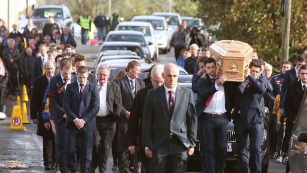 The remains of Niall Donoghue are carried by hurling colleagues through Kilbeacanty. Photograph: Joe O’Shaughnessy