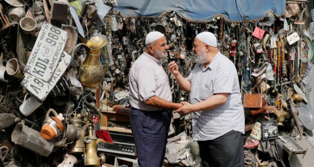 Elderly men talk to each other in downtown Amman. Photograph: Muhammad Hamed/Reuters