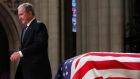 Former US president George W Bush walks past the casket of his father, former US president George HW Bush, at the State funeral at the National Cathedral, in Washington, DC on December 5th Photograph: Alex Brandon/Pool/EPA