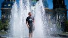 A boy cools down  a fountain in Berlin, Germany during the heatwave. Photogtaph: Kay Nietfeld/dpa/AP