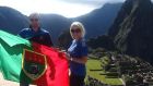 Lainey Broderick with her husband holding a Mayo flag in Macchu Piccu in Peru. 