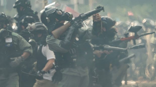 Riot police aim with teargas launchers during an escape of protesters at The Hong Kong Poytechnic University in Hong Kong. Photograph: Anthony Kwan/Getty Images.