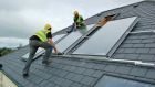Workers install solar panels on a roof. Areas with newer builds have a higher proportion of A-rated homes. Photograph: courtesy of Construct Ireland
