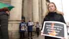 November 2019: Ciara Holland, owner of a defective apartment built by Tudor Homes, protests with supporters outside the Four Courts. Photograph: Dara Mac Dónaill/The Irish Times