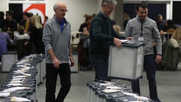A count staff member carries a ballot box before votes are counted at a counting centre in Citywest on Sunday. Photograph: Lorraine O’Sullivan/Reuters