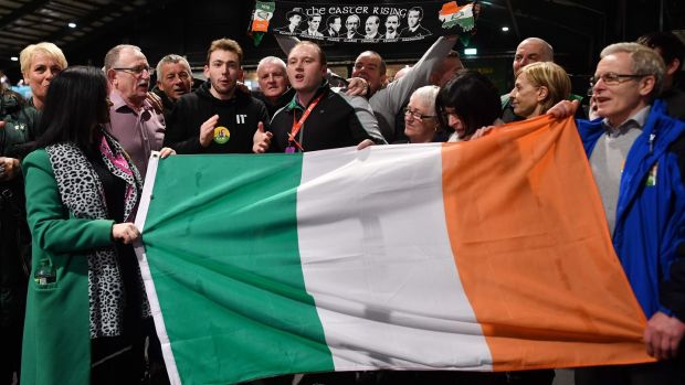 Sinn Féin party supporters sing as they hold a flag during the count in the RDS centre in Dublin. Photograph: Ben Stansall/AFP via Getty Images