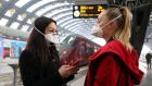 Travellers wear protective face masks at Central Station, Milan, Italy. Photograph: Matteo Bazzi/EPA