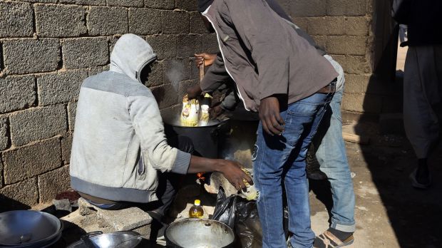 African migrants prepare food at a Safe House in the 'ghost city' of Bani Walid, on the edge of the desert 170km southeast of the Libyan capital Tripoli in 2017. Photograph: Mahmud Turkia/AFP via Getty Images