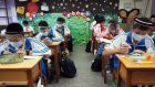 Students wear plastic face shields at the Nankan Junior High School in Taoyuan City, Taiwan: testing, contact tracing, travel bans, quarantines and masks in public places are Asian defence tools. Photograph: David Chang