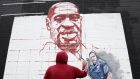 Work on a Falls Road mural of George Floyd who was murdered by police in Minneapolis. Protests took place across the world, including in Belfast and Dublin. Photograph: Pacemaker Press