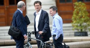 Tánaiste Simon Coveney (left) and  Minister for Finance Paschal Donohoe (right) greet Green Party leader Eamon Ryan as he arrives at Government Buildings. Photograph: Alan Betson/The Irish Times