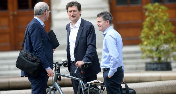 Tánaiste Simon Coveney (left) and  Minister for Finance Paschal Donohoe (right) greet Green Party leader Eamon Ryan as he arrives at Government Buildings. Photograph: Alan Betson/The Irish Times