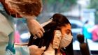 A hairdresser at work   in New Delhi, India. Hair and beauty salons were due to reopen on July 20th but that date is now being brought forward. File photograph: Prakash Singh/AFP via Getty Images