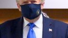 President Donald Trump in a mask on a rare occasion: his resistance to wearing a mask has turned it into a marker of political affiliation. Photograph: Erin Scott/New York Times